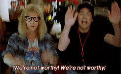 a scene from Wayne's world where Wayne and Garth are bowing over in praise of Alice Cooper